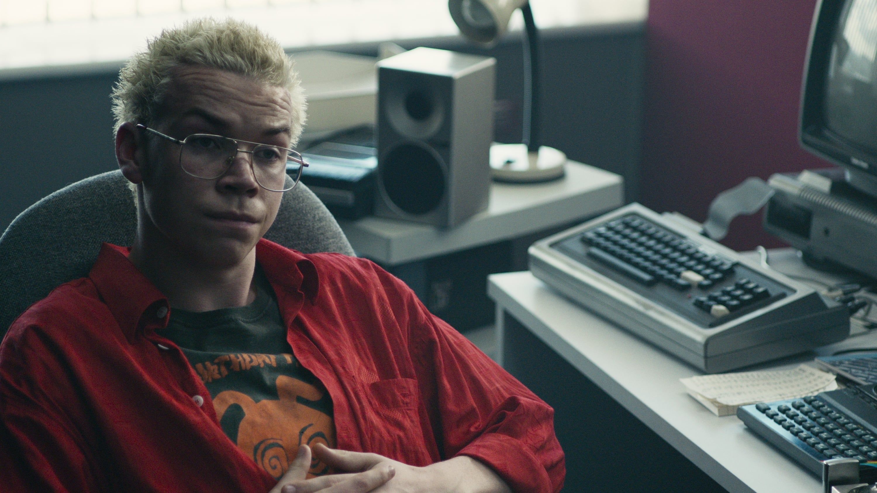 Black Mirror: Bandersnatch co-star Will Poulter lounges in a desk chair.