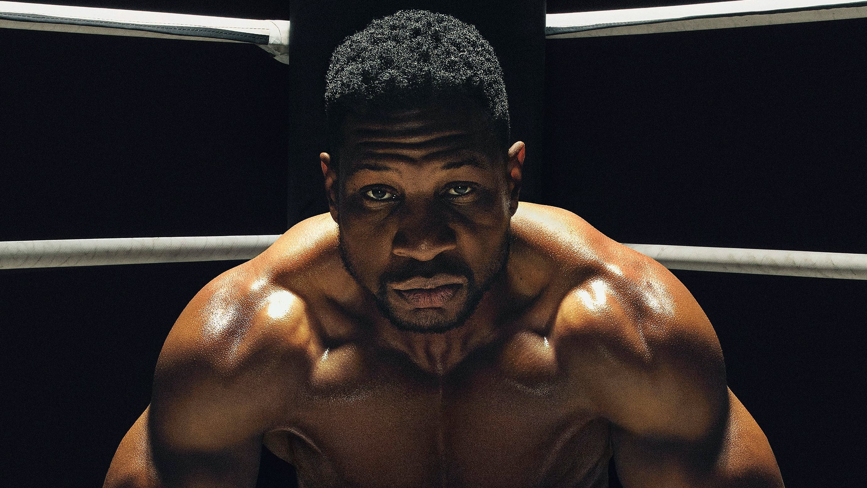 Jonathan Majors hunched over in the corner of a boxing ring.